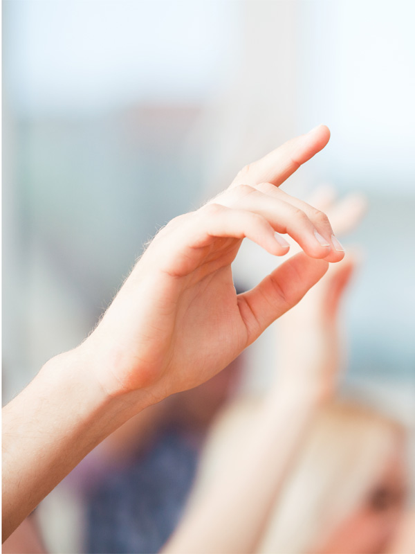 Students Raising hands in classroom